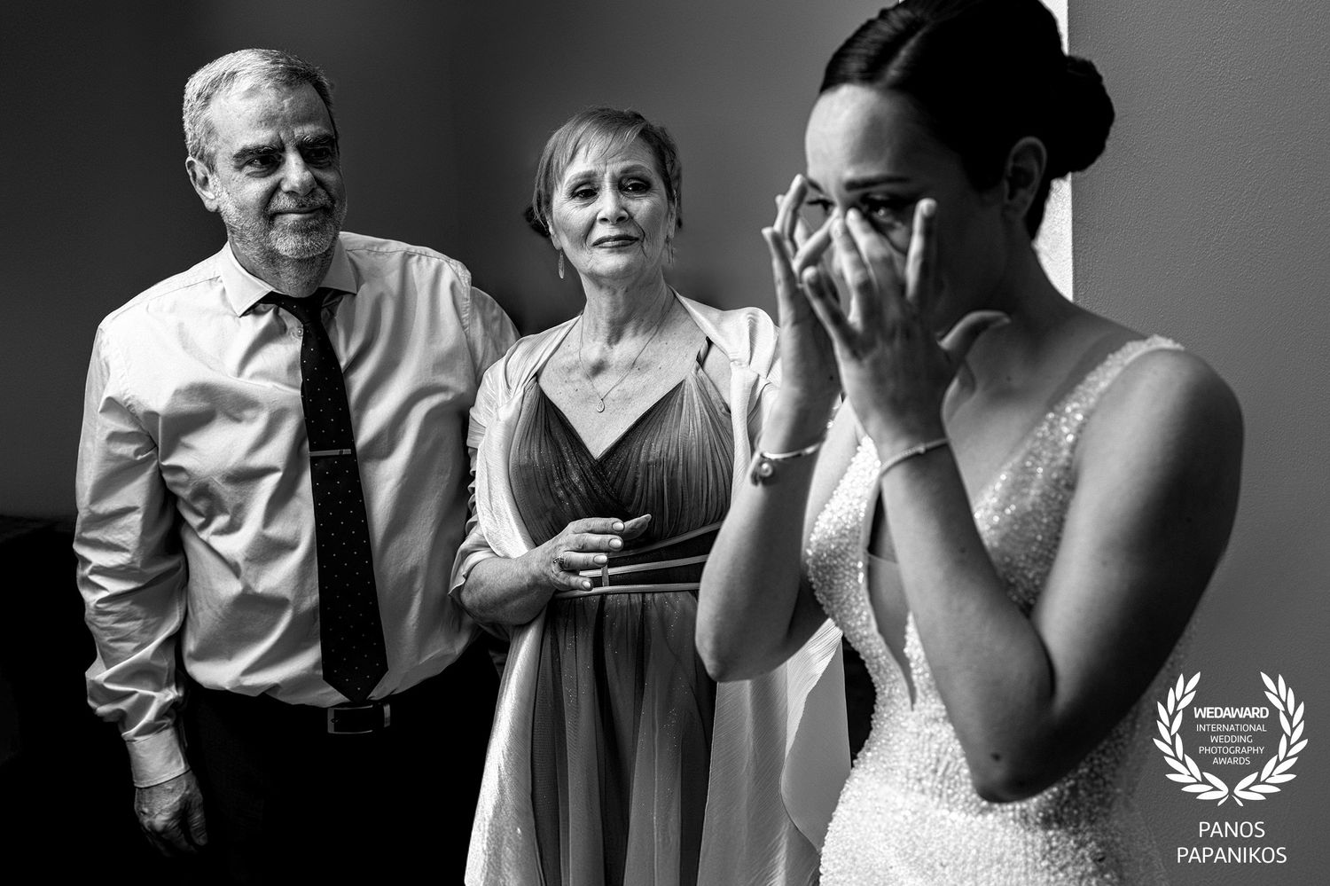 Black and white candid emotional moment during wedding preparation.