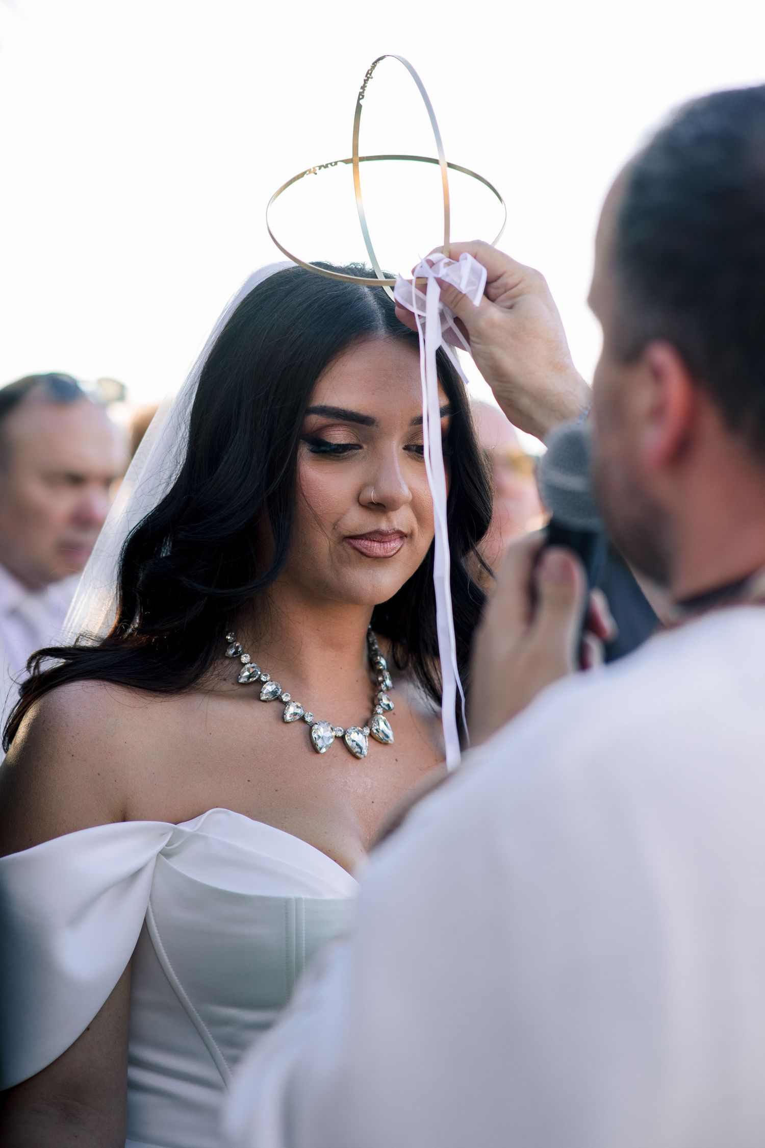 Traditional wedding crowning ceremony with delicate white crowns.