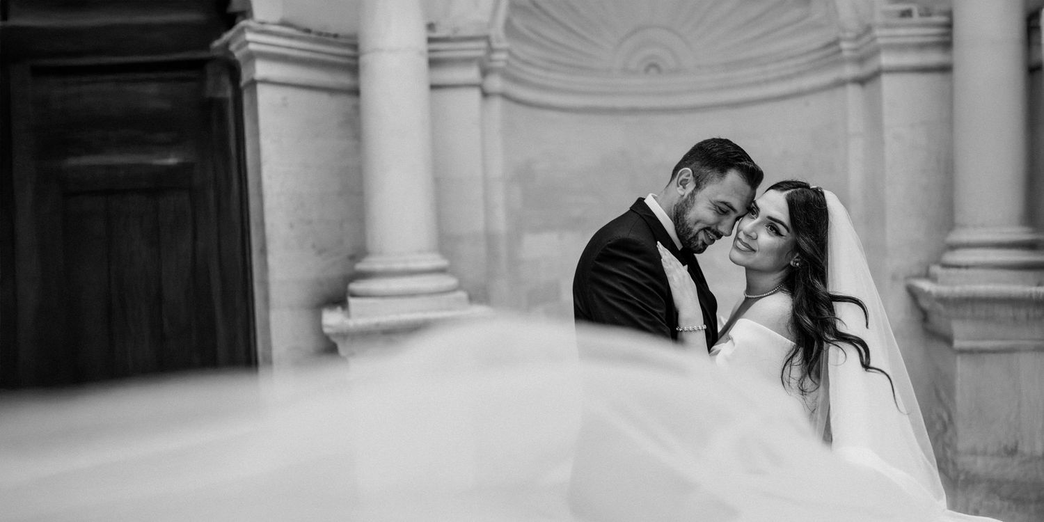 Black and white wedding portraits showcase elegant architectural details and columns.