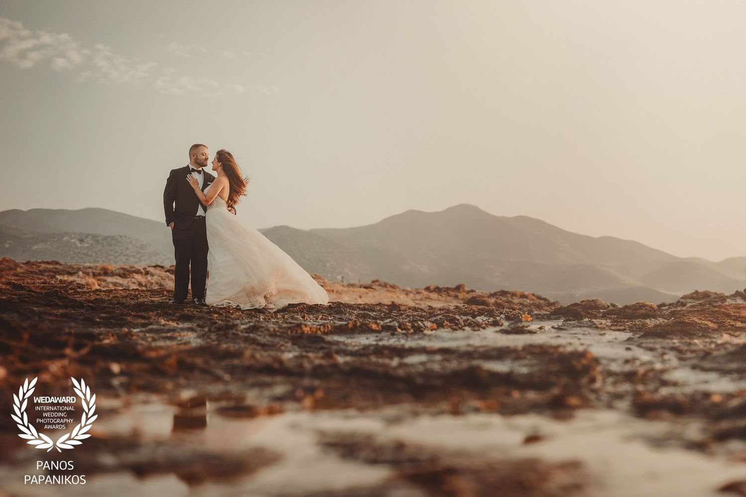 Desert landscape wedding photography with warm tones and distant mountains.