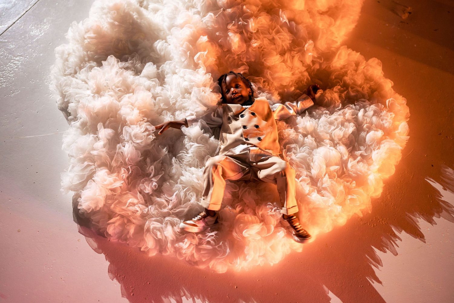 A dramatic wedding photo with orange smoke effects creating an ethereal atmosphere.