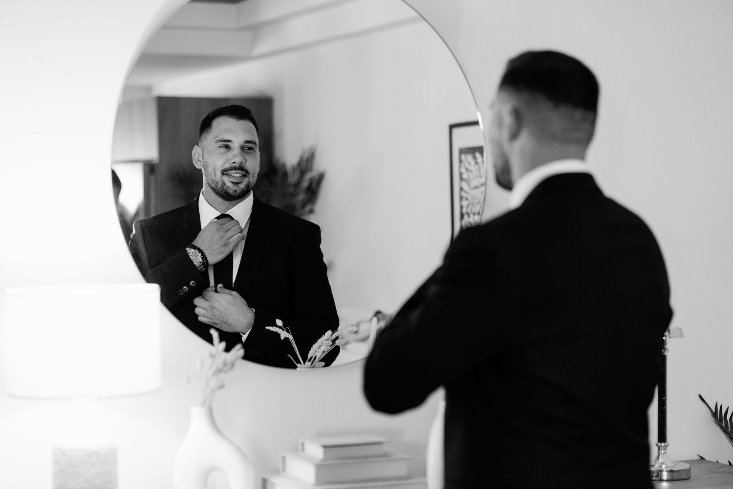 Series of black and white shots showing two people adjusting formal attire.