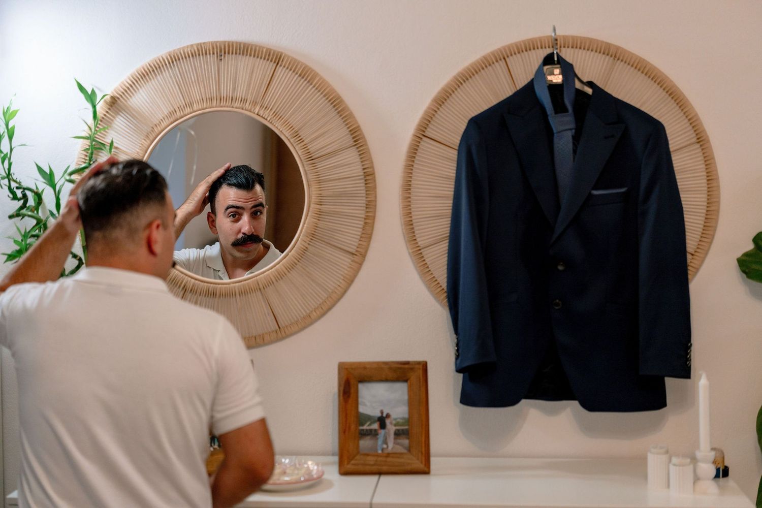 Reflection in round mirror showing formal attire preparation.