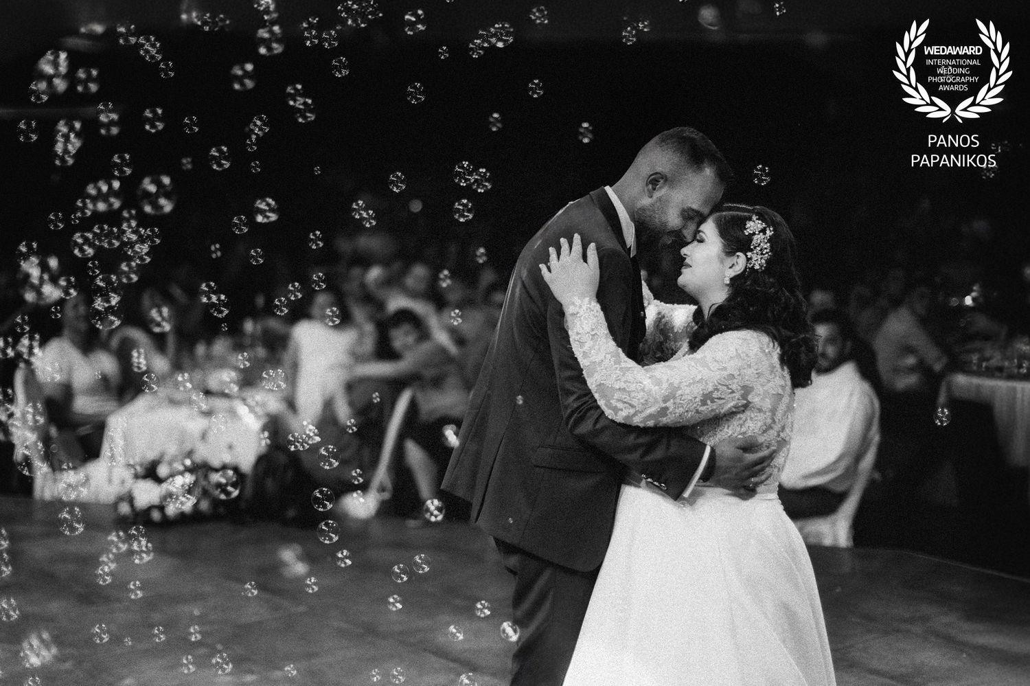 Wedding celebration with floating bubbles creating a magical nighttime atmosphere.