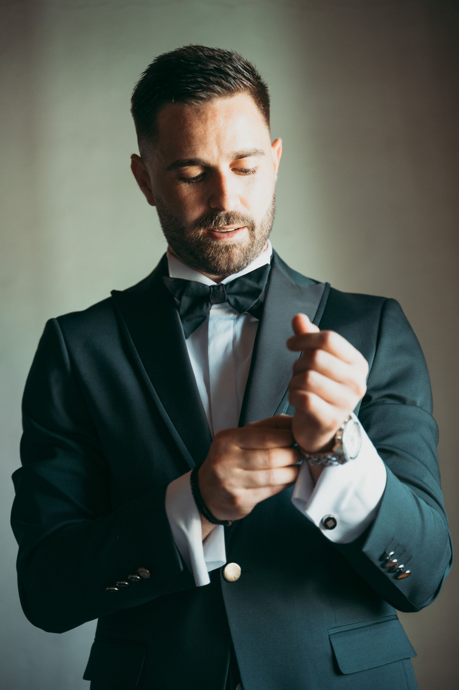 Close-up shots of hands adjusting formal wear cufflinks and buttons.