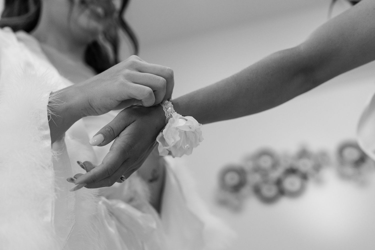 Close-up black and white shots of hands working on detailed preparations.
