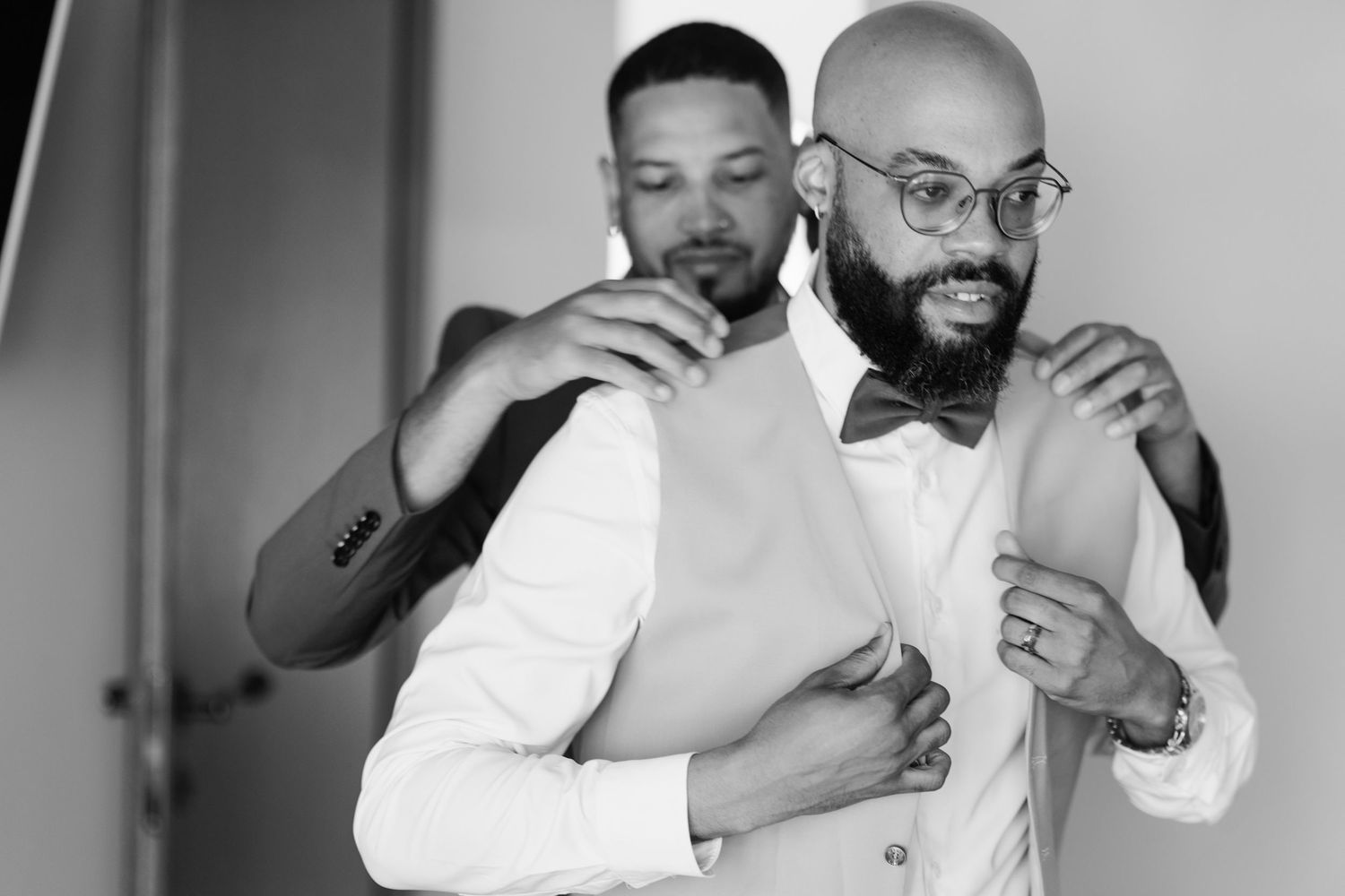 Black and white candid moments during wedding preparations.