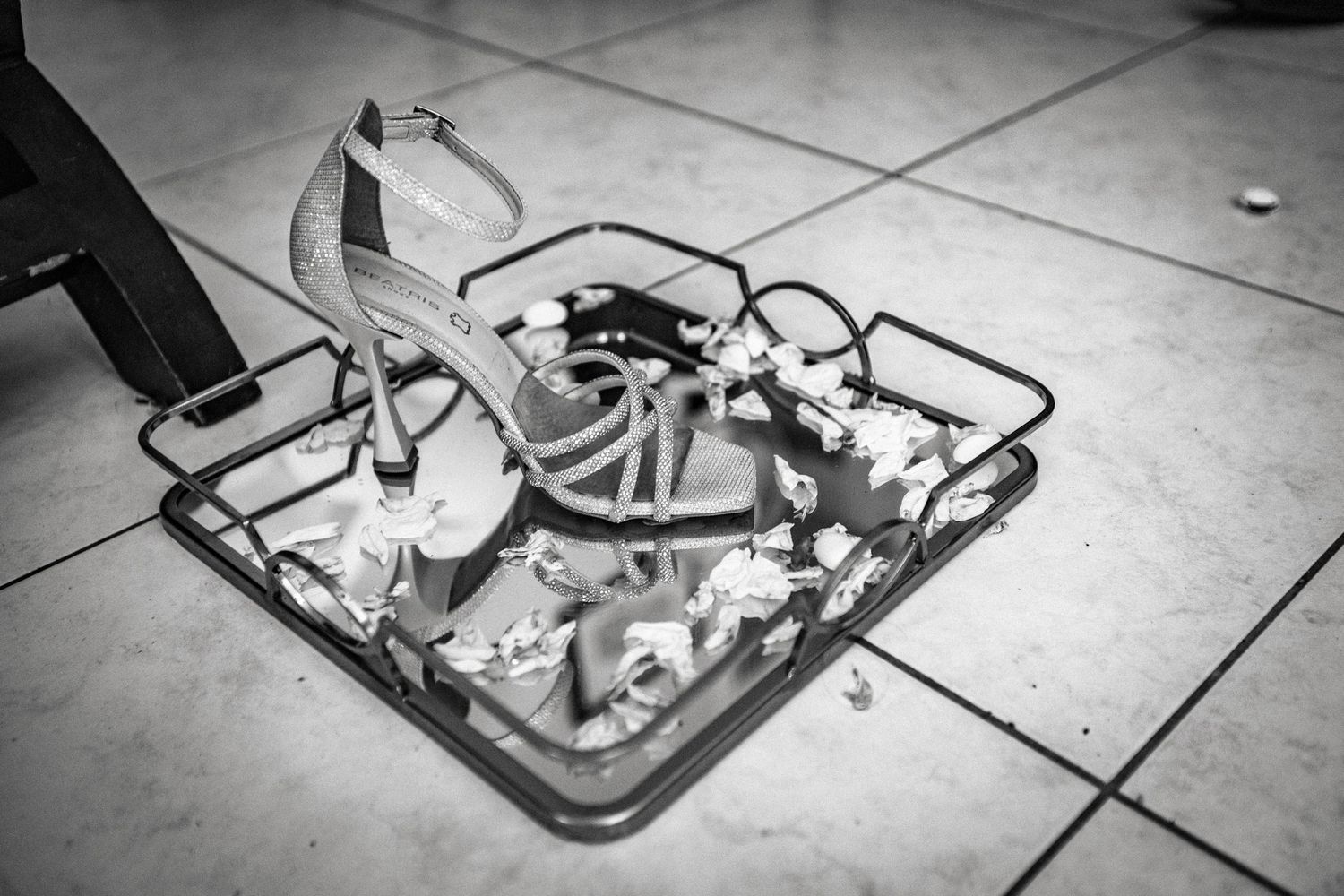 Vintage camera equipment and accessories laid out on a tiled floor.