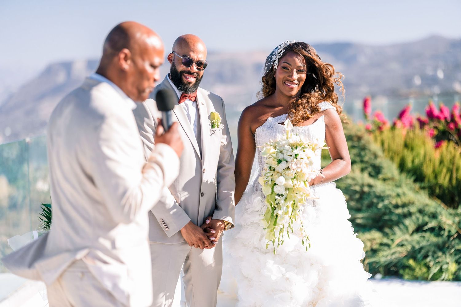 Wedding celebration on a sunny terrace overlooking mountain landscapes.