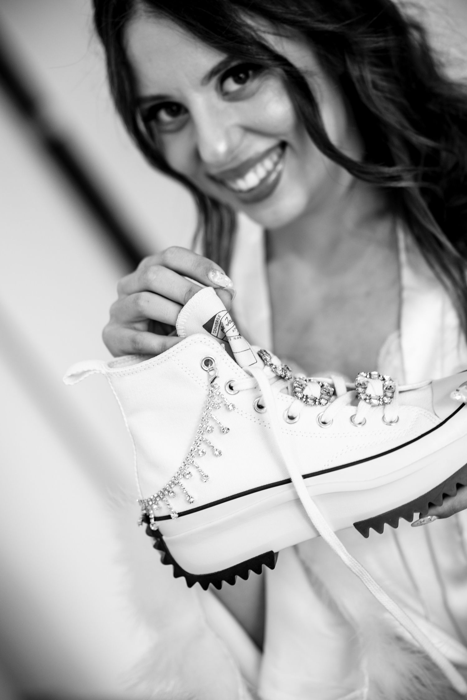 White studded wedding sneakers shown in a black and white artistic photo sequence.