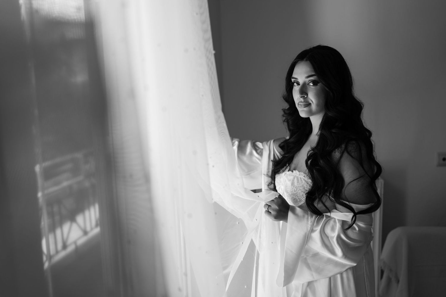 Black and white portrait series near a window with natural light.