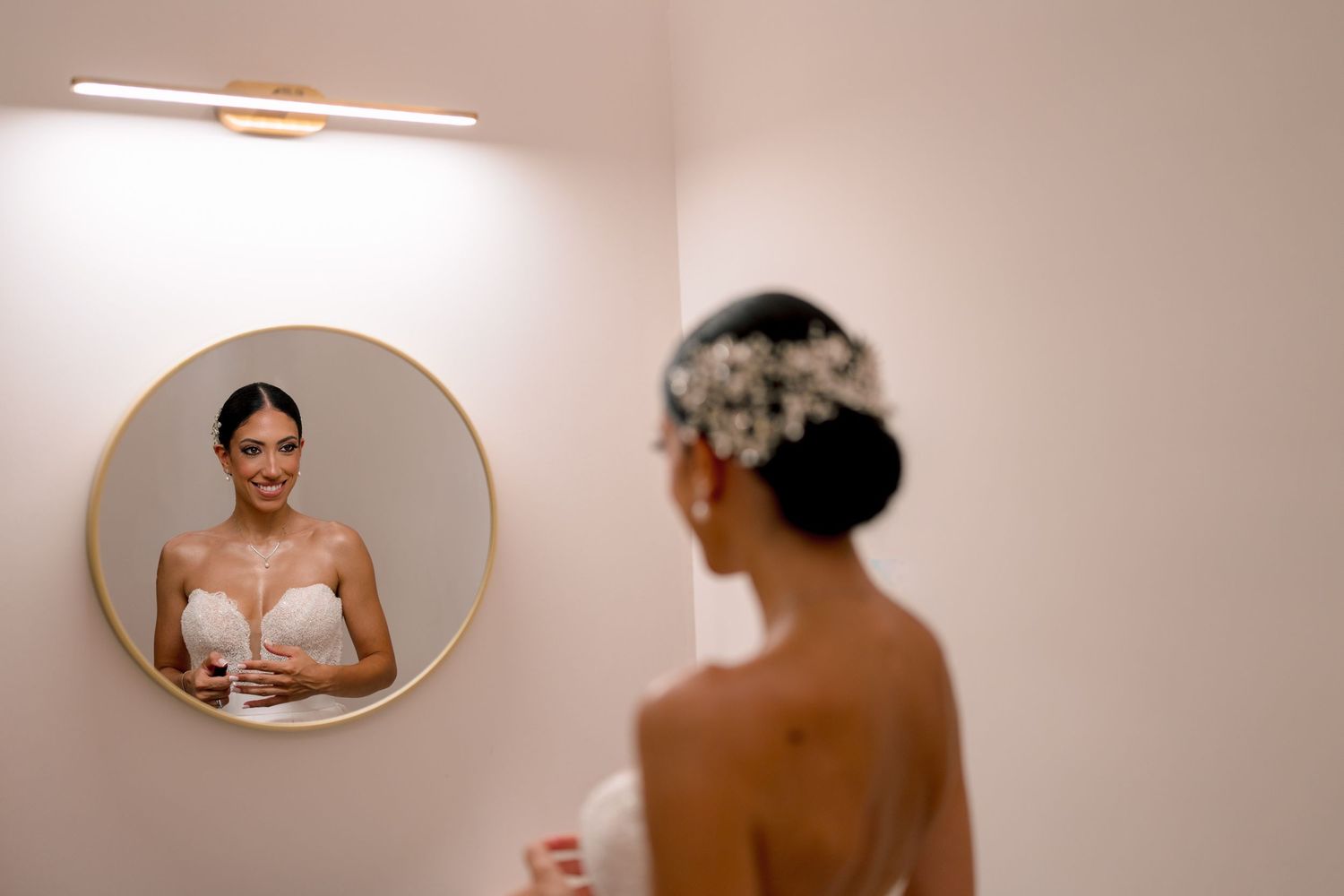 Soft-lit mirror reflections capture intimate bridal getting-ready moments.