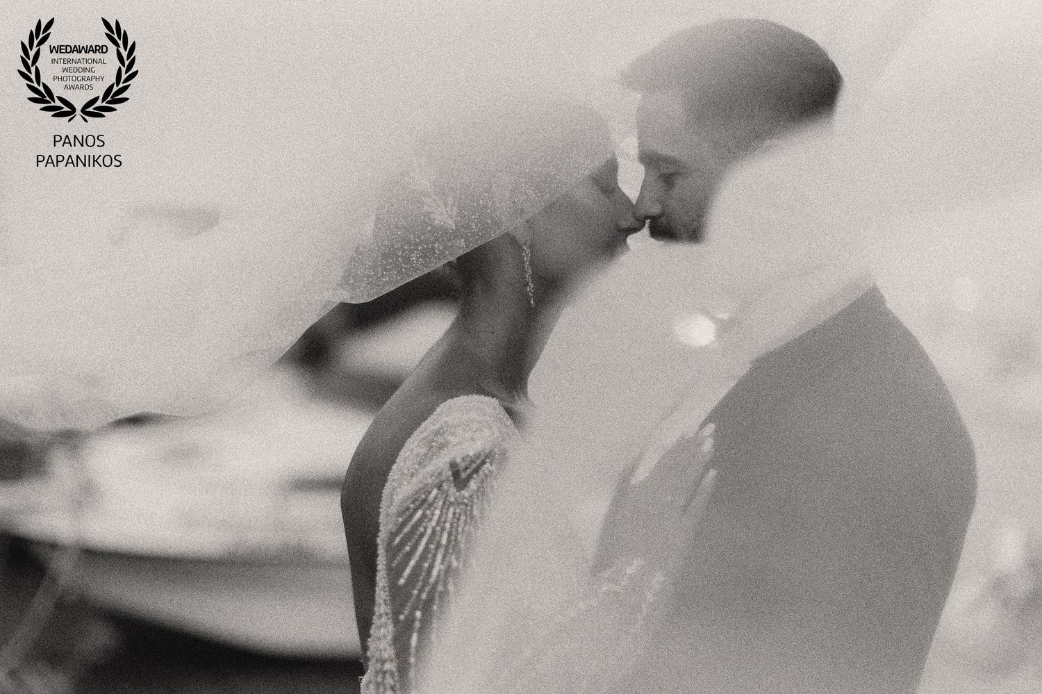 Artistic black and white wedding portrait with soft focus and dreamy effects.