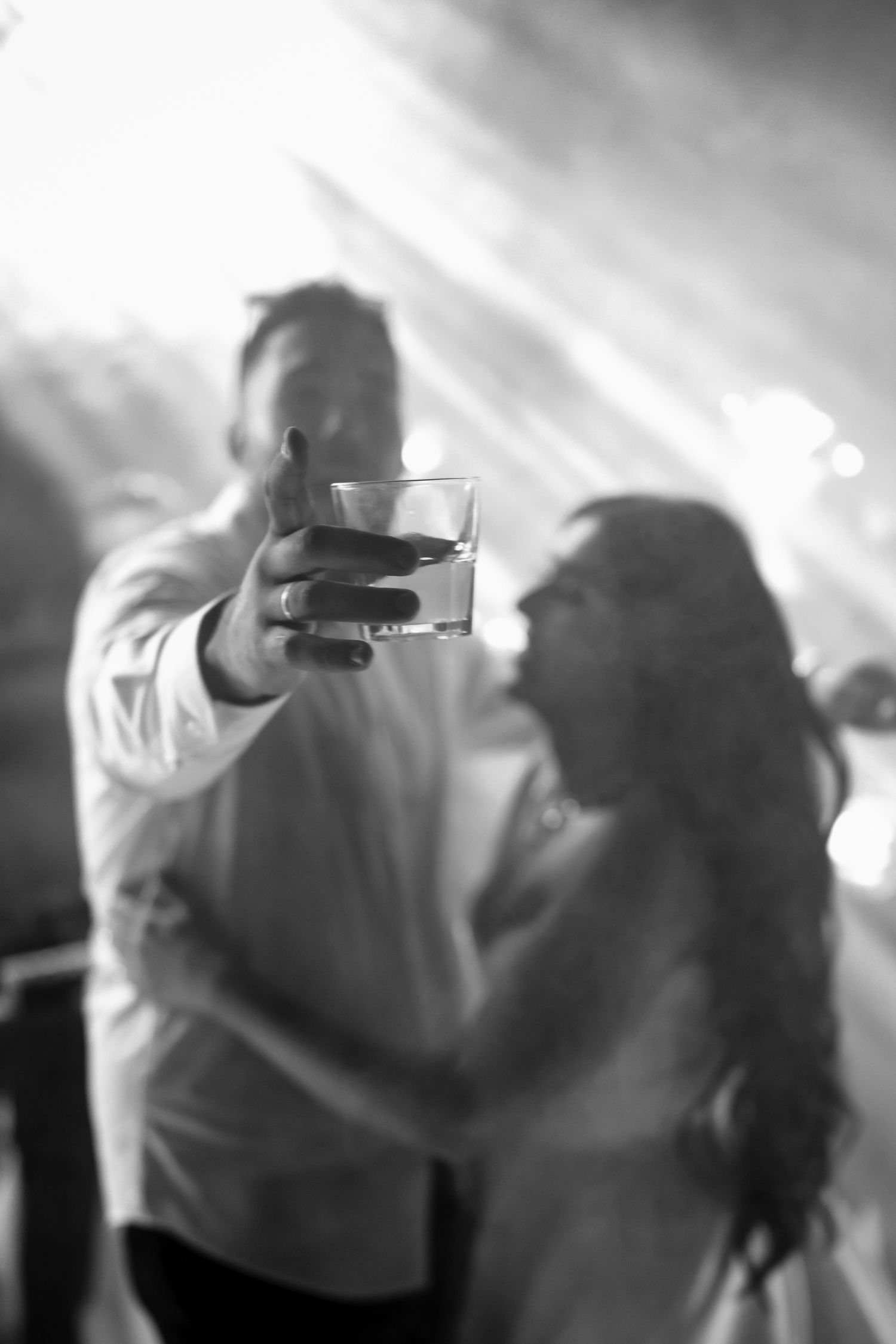 Ethereal dance floor scene with soft lighting and silhouettes in motion.