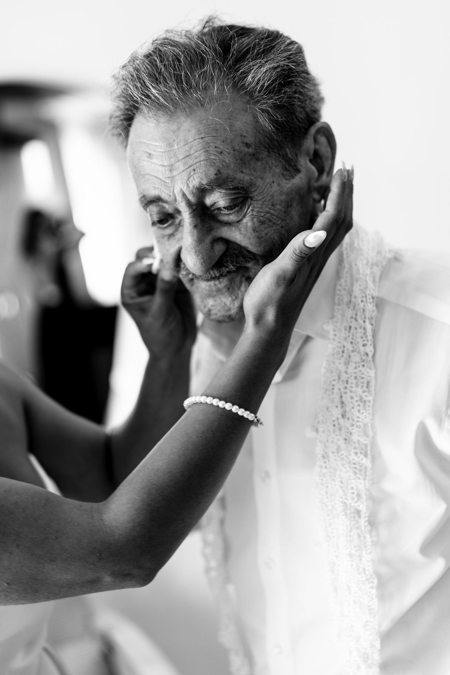 Black and white emotional portrait showing tender touch and connection.