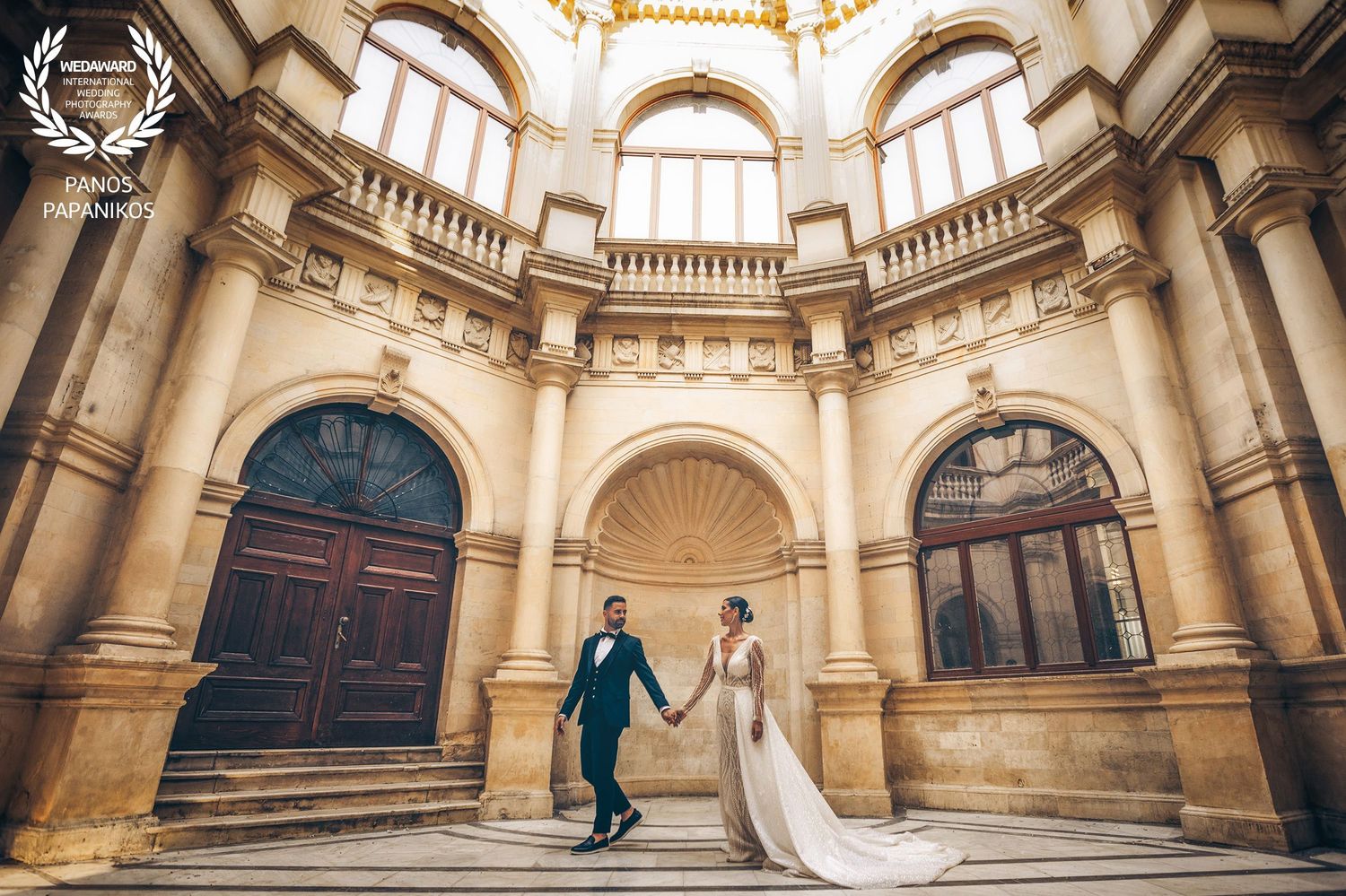 Elegant baroque architecture interior with ornate columns and arches in a historic building.