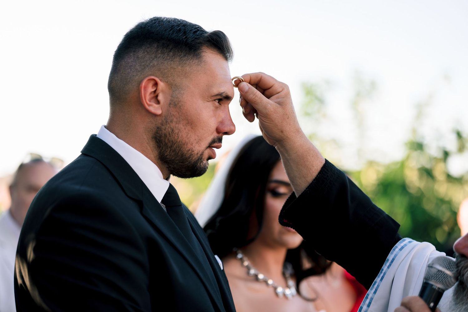 Intimate moment during an outdoor wedding ceremony.