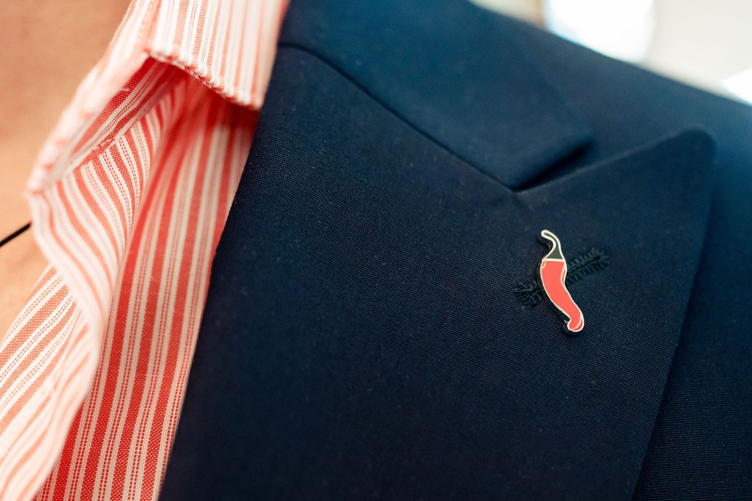 Close-up detail of pink striped fabric against navy blue background.