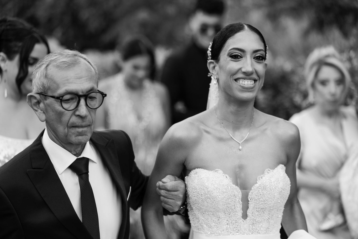 Black and white candid shots of wedding party members sharing joyful moments.