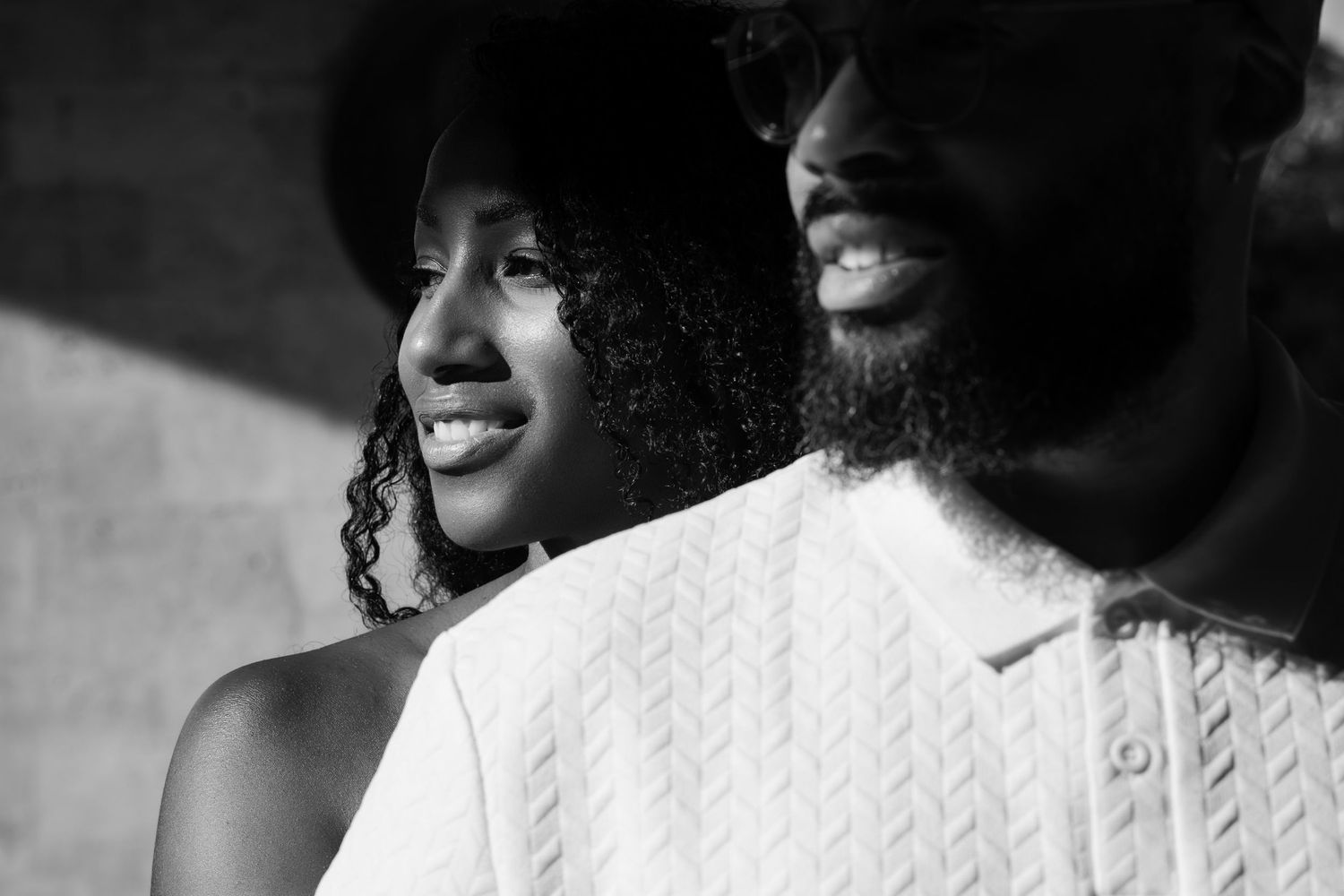 Close-up black and white portrait showing joyful expressions.