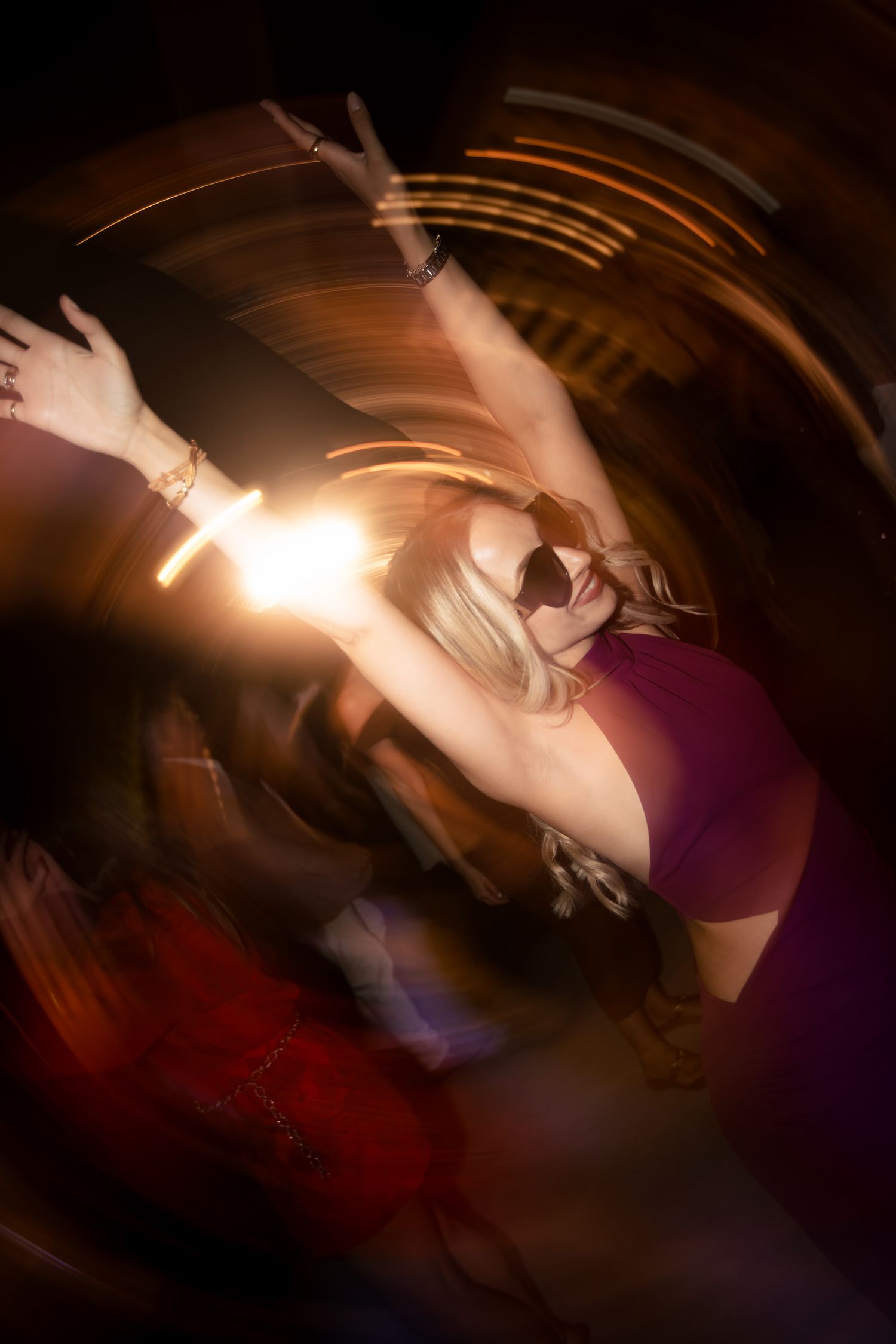 Artistic long exposure shot capturing dancing movement in warm tones.