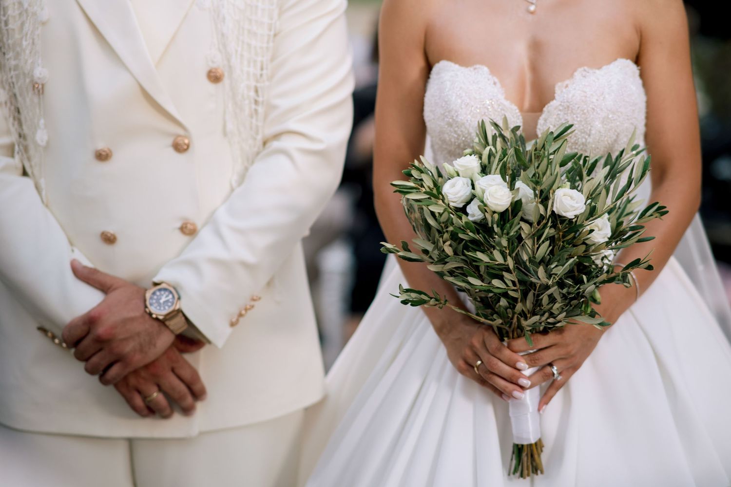 Elegant bridal details featuring white wedding dress, bouquet and classic accessories.