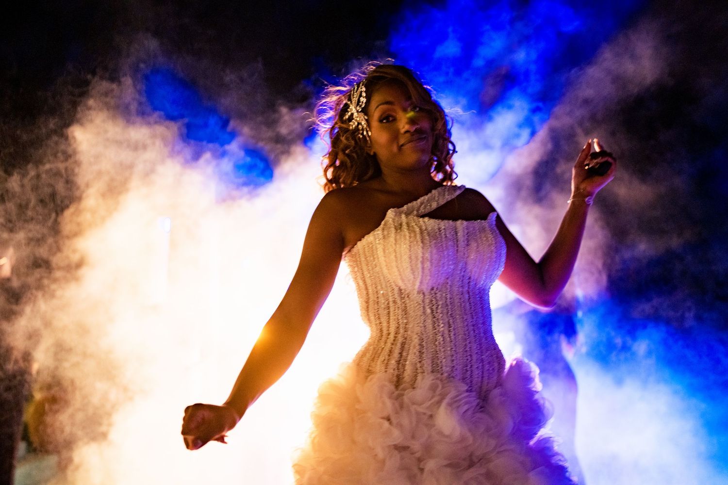 Dramatic blue fog creates ethereal atmosphere on dance floor.