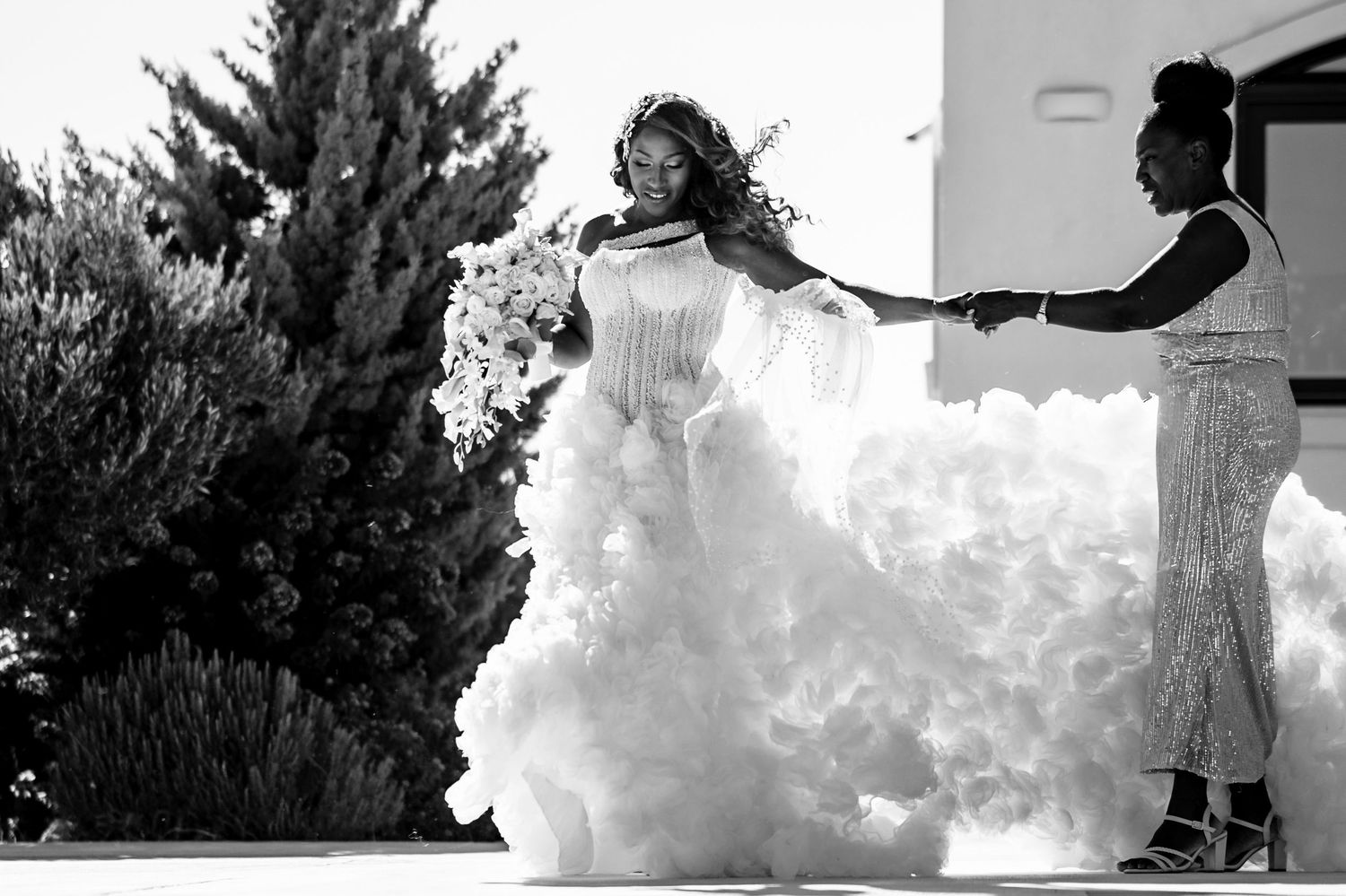 Artistic black and white wedding photography with flowing fabric and natural elements.