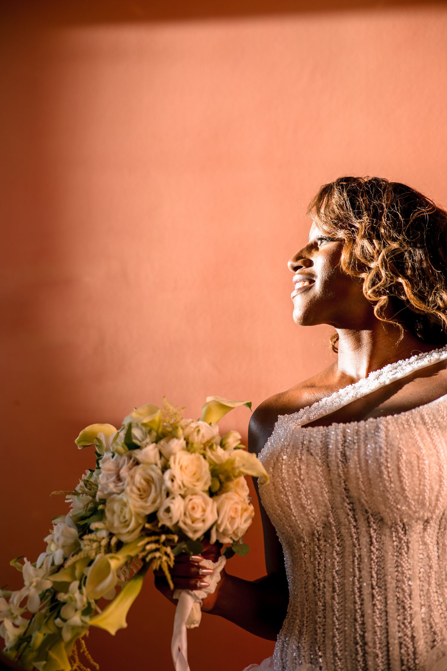 Artistic bridal portraits with warm lighting and peach roses.