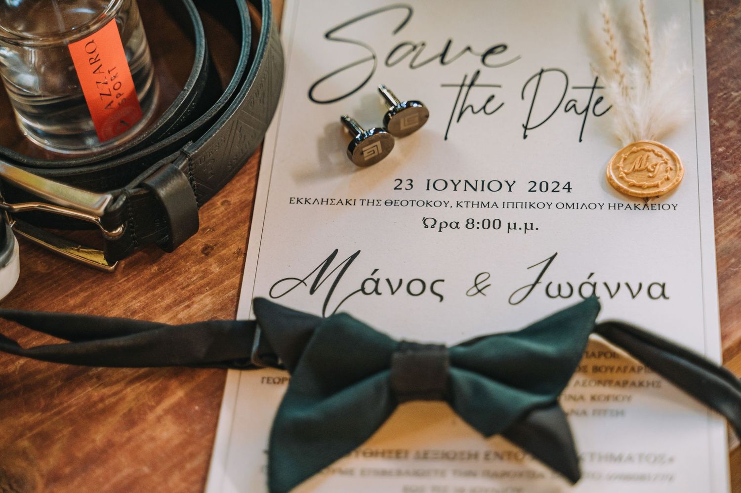 Save the date invitation with navy blue bow tie detail and elegant calligraphy.