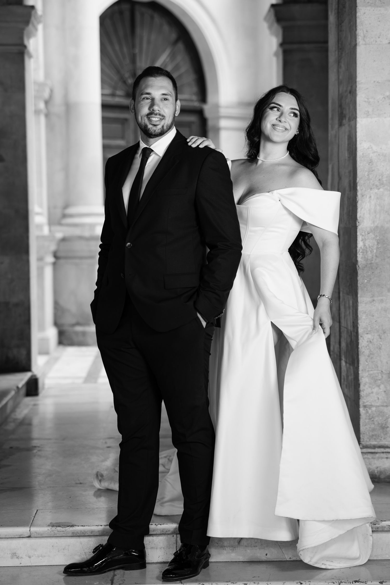 Black and white wedding portraits showcasing elegant architectural details.