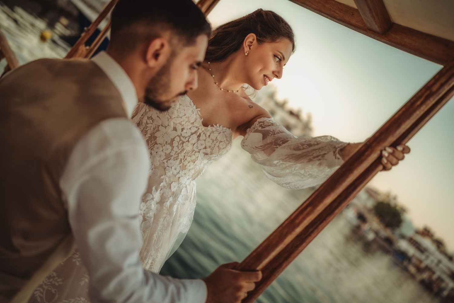 Wedding photography sequence captured on a classic wooden boat against a waterfront backdrop.