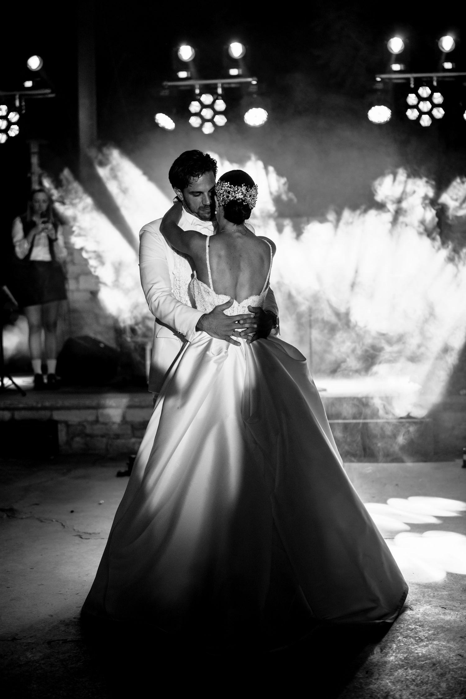 Romantic black and white dance moment captured with dramatic stage lighting and smoke effects.