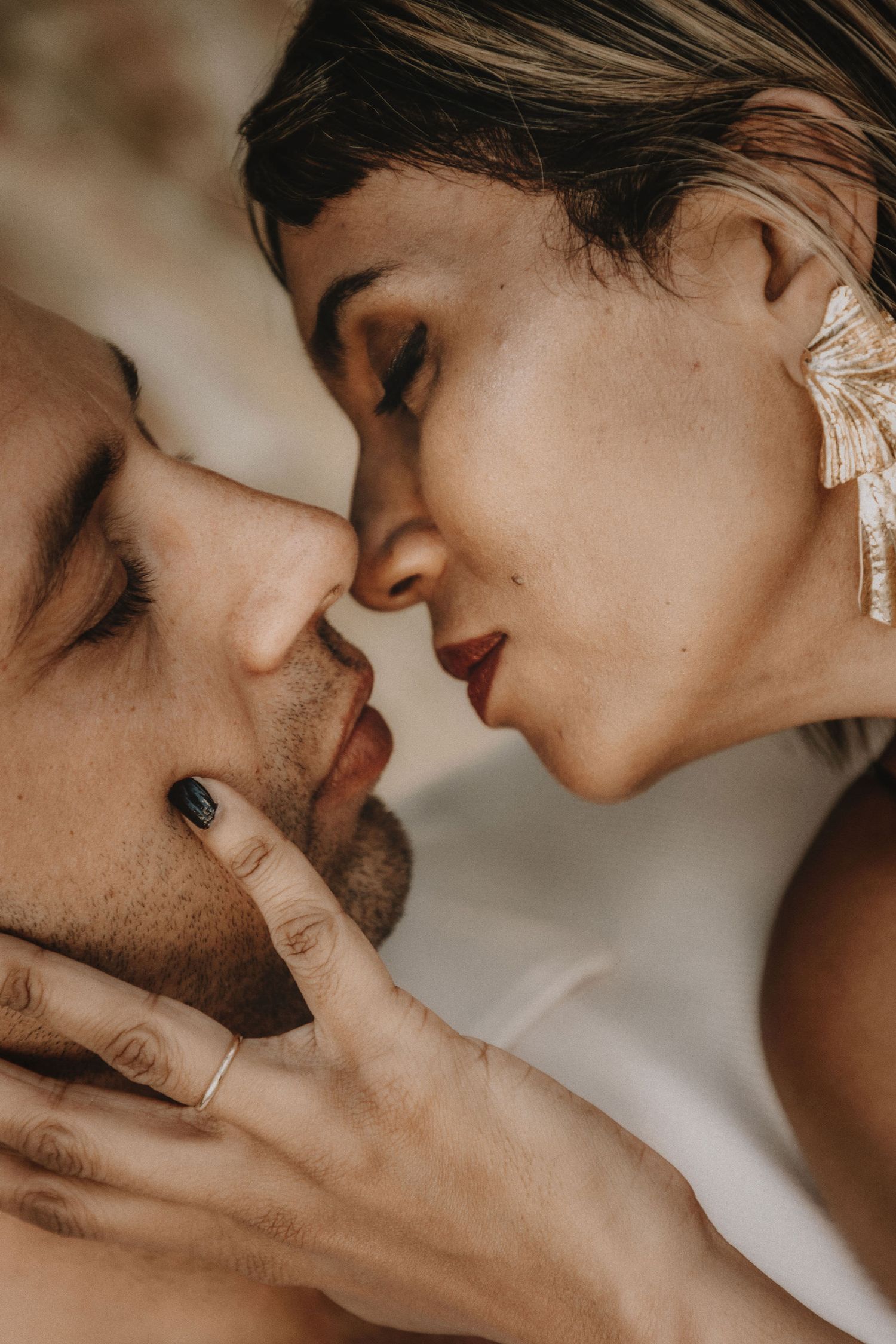 Romantic sepia-toned close-up portraits showing intimate moments between a couple.