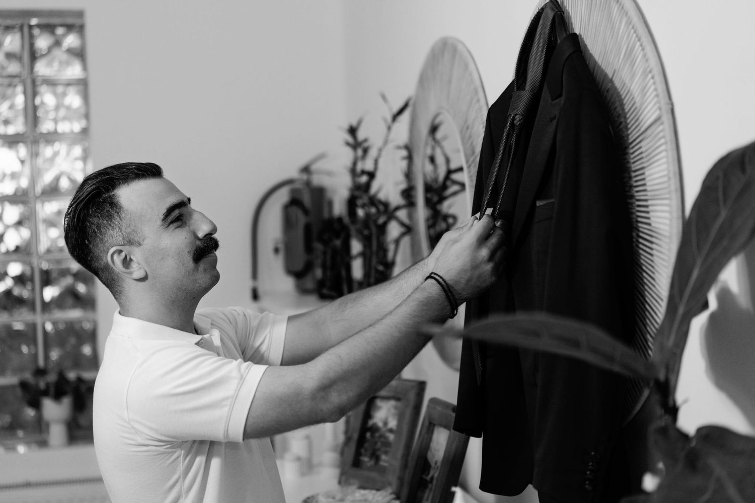 Getting ready scene with formal attire being prepared on hangers.