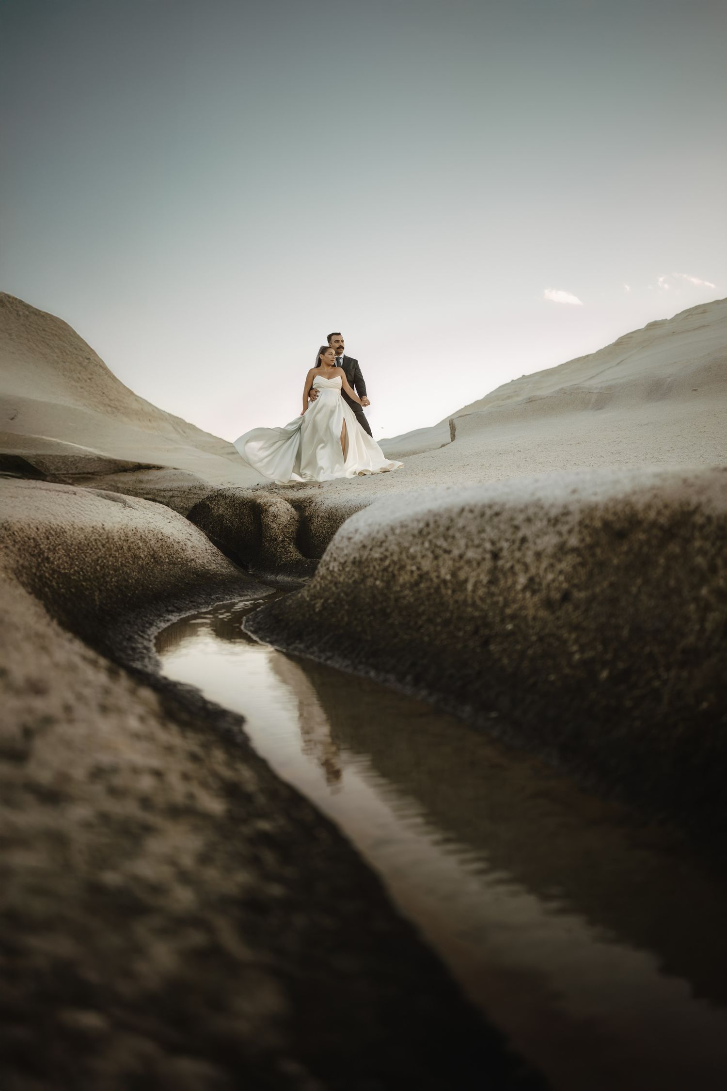 Artistic wedding photography showing a winding path through rocky terrain.