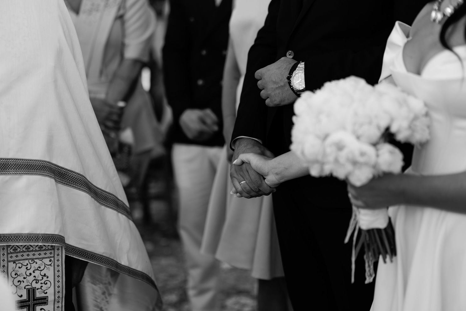 Wedding ceremony details with white floral arrangements.
