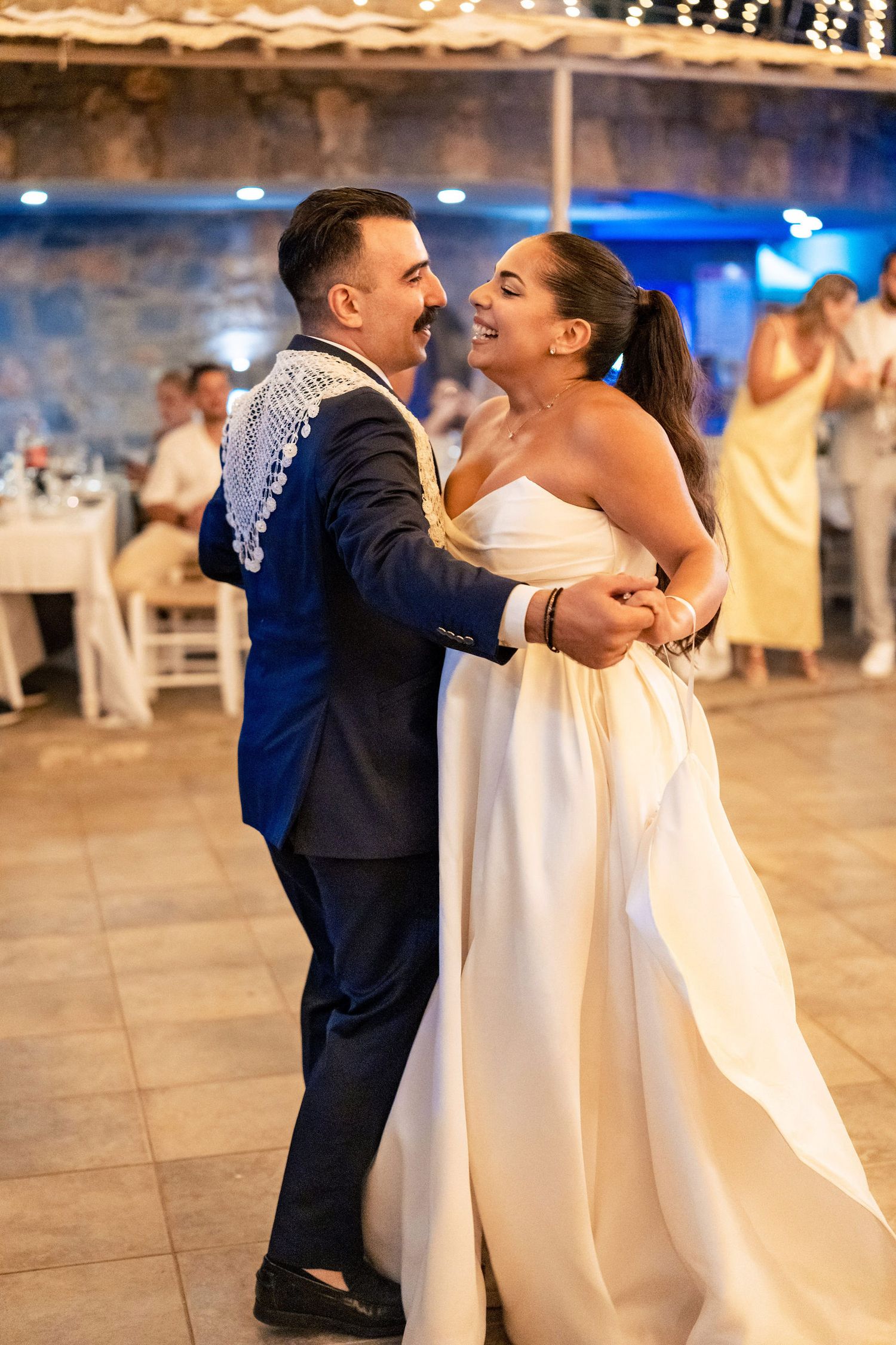 A couple shares a romantic dance moment on an outdoor dance floor.
