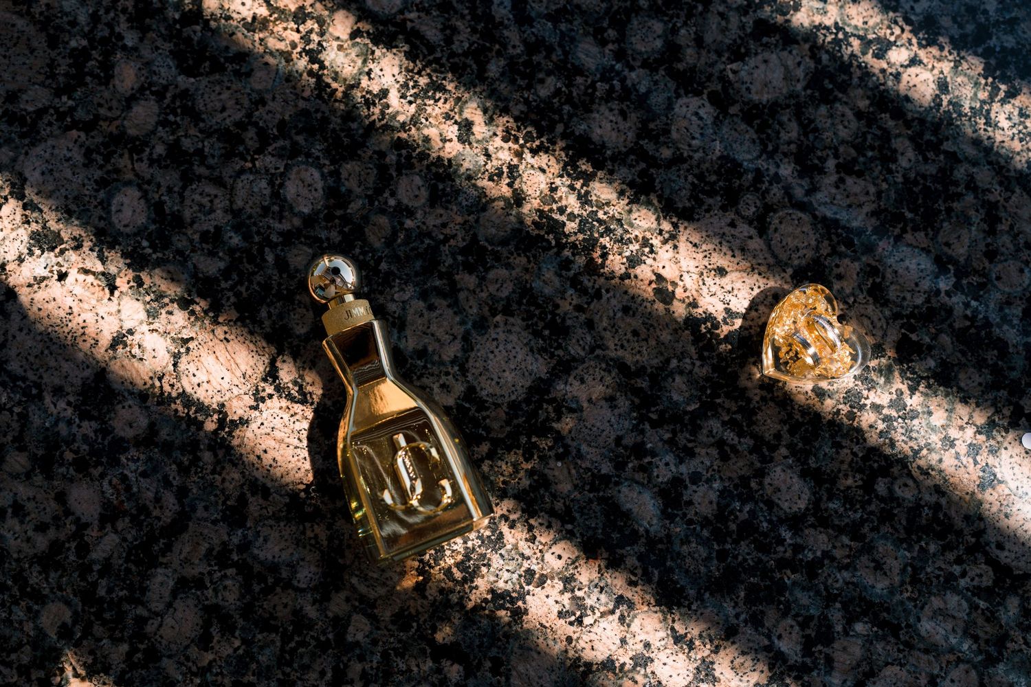 Decorative golden light fixtures cast warm glowing patterns on a dark textured wall.