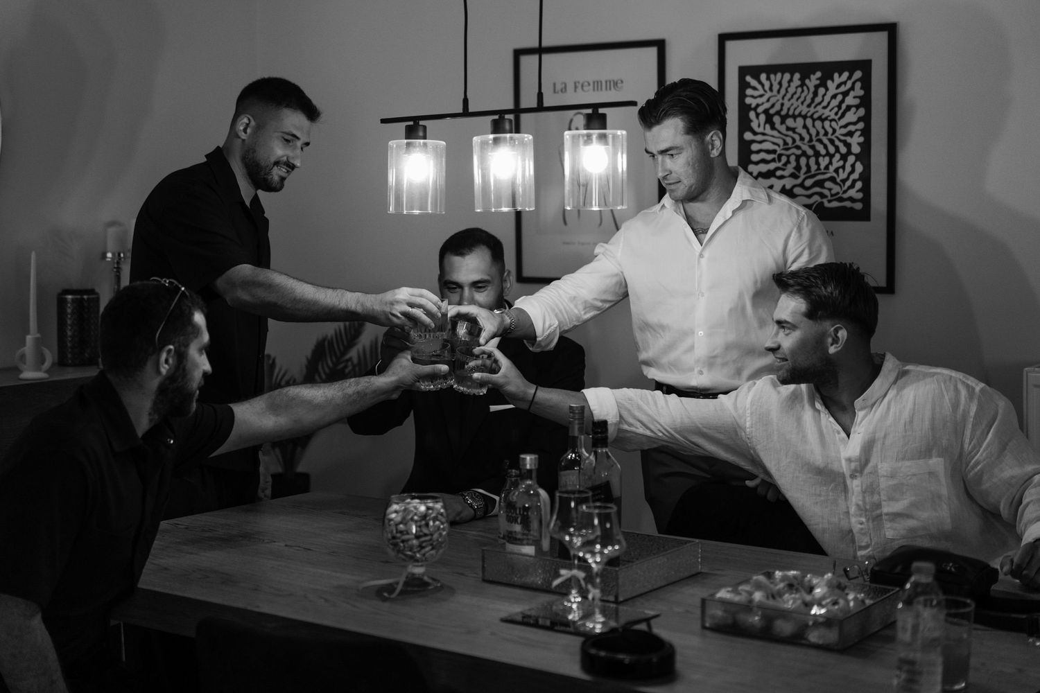 Black and white scenes of formal gathering with glassware and table settings.