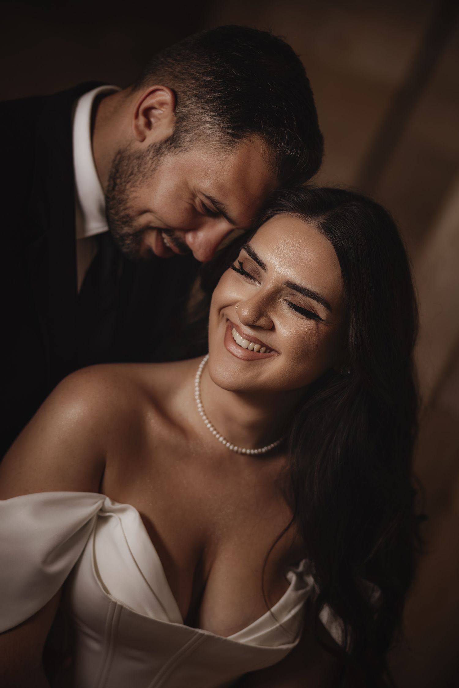 An intimate wedding portrait capturing a tender moment between newlyweds.