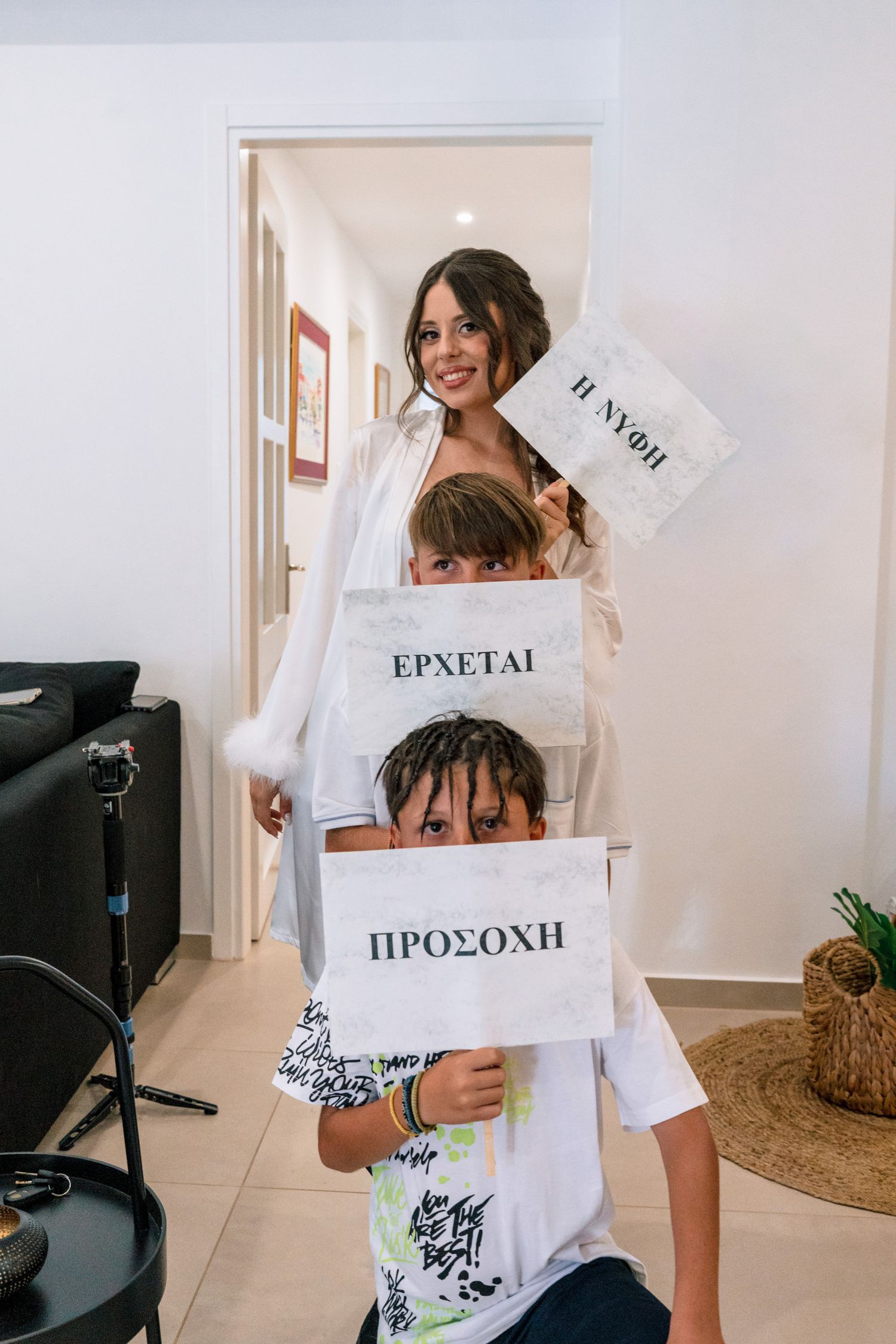 Someone holds up multiple white signs with text in different languages during a photoshoot.
