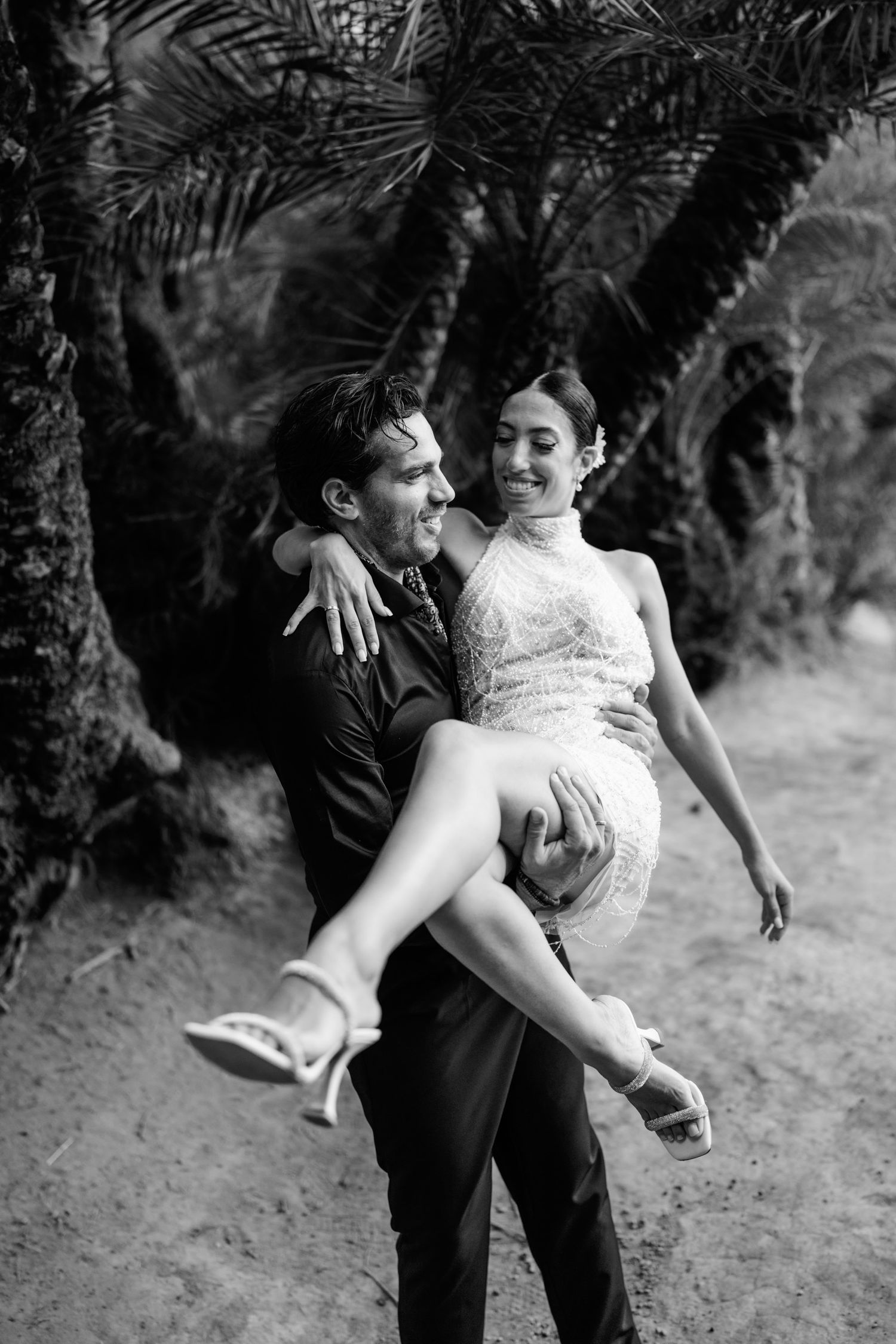 Playful moment captured in a palm tree oasis with natural lighting.