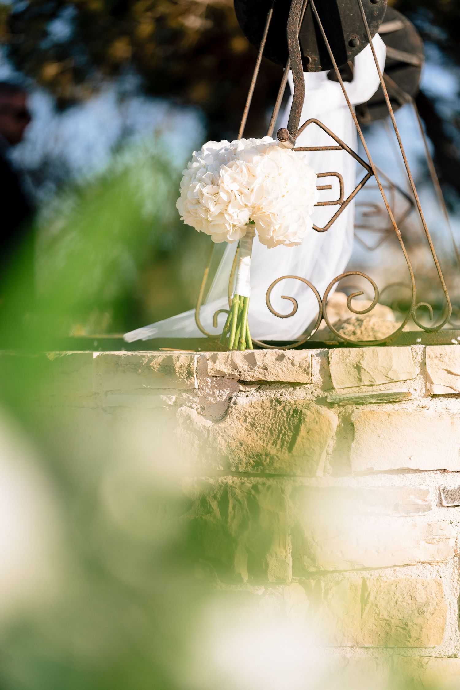 White decorative elements and floral arrangements create an elegant outdoor wedding setting.