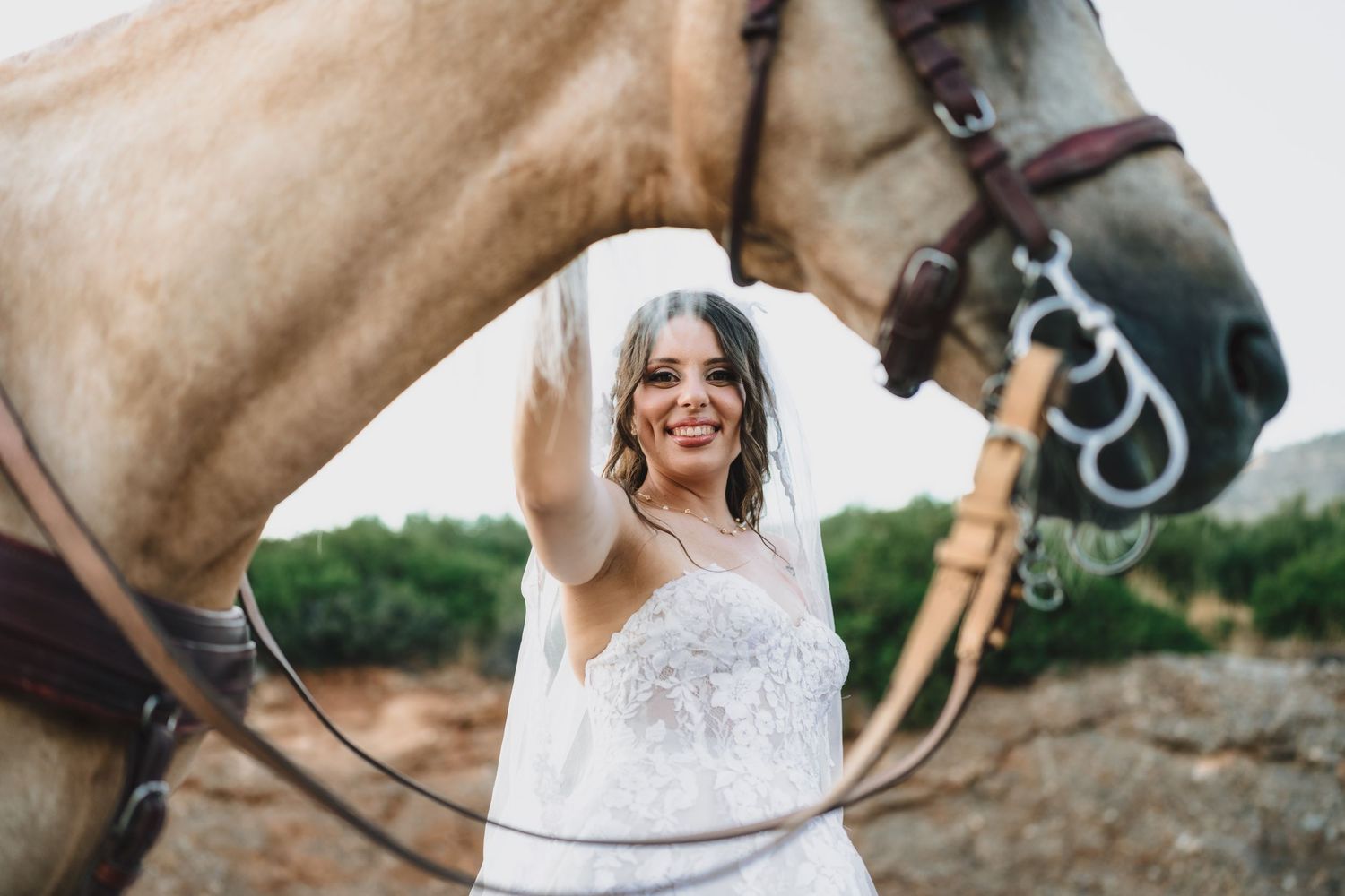 Close-up shots of bride interacting with light brown horse during wedding photoshoot.