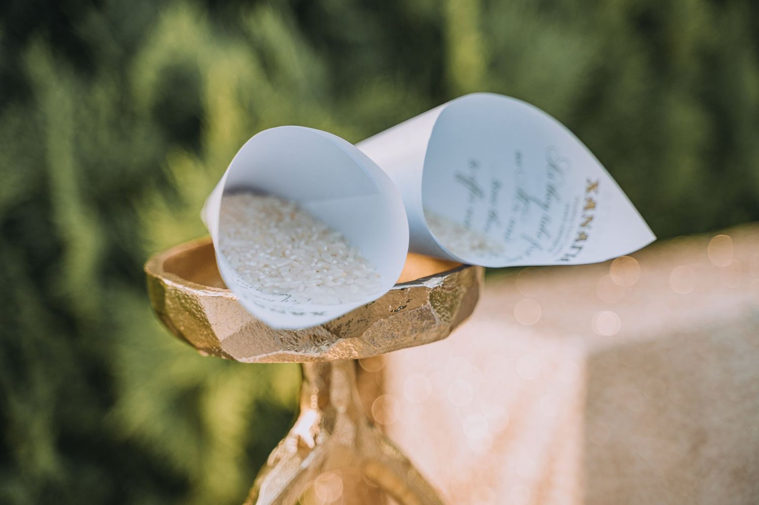 Delicate paper wedding details arranged artistically in natural outdoor lighting.