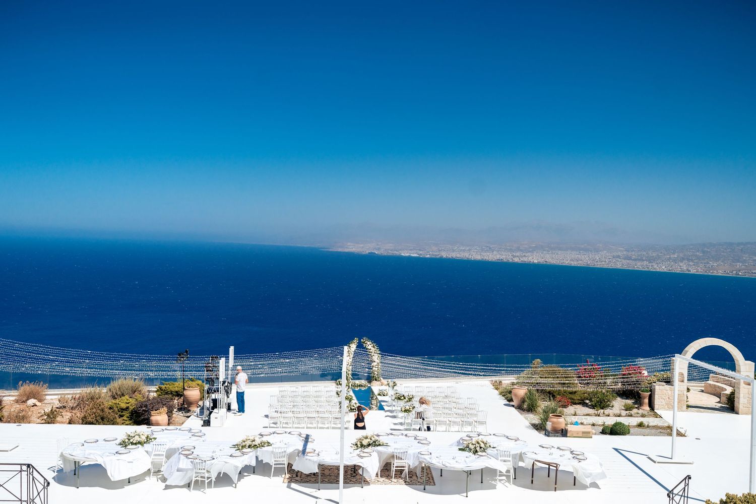 Stunning panoramic view of white buildings and blue ocean in Santorini, Greece.
