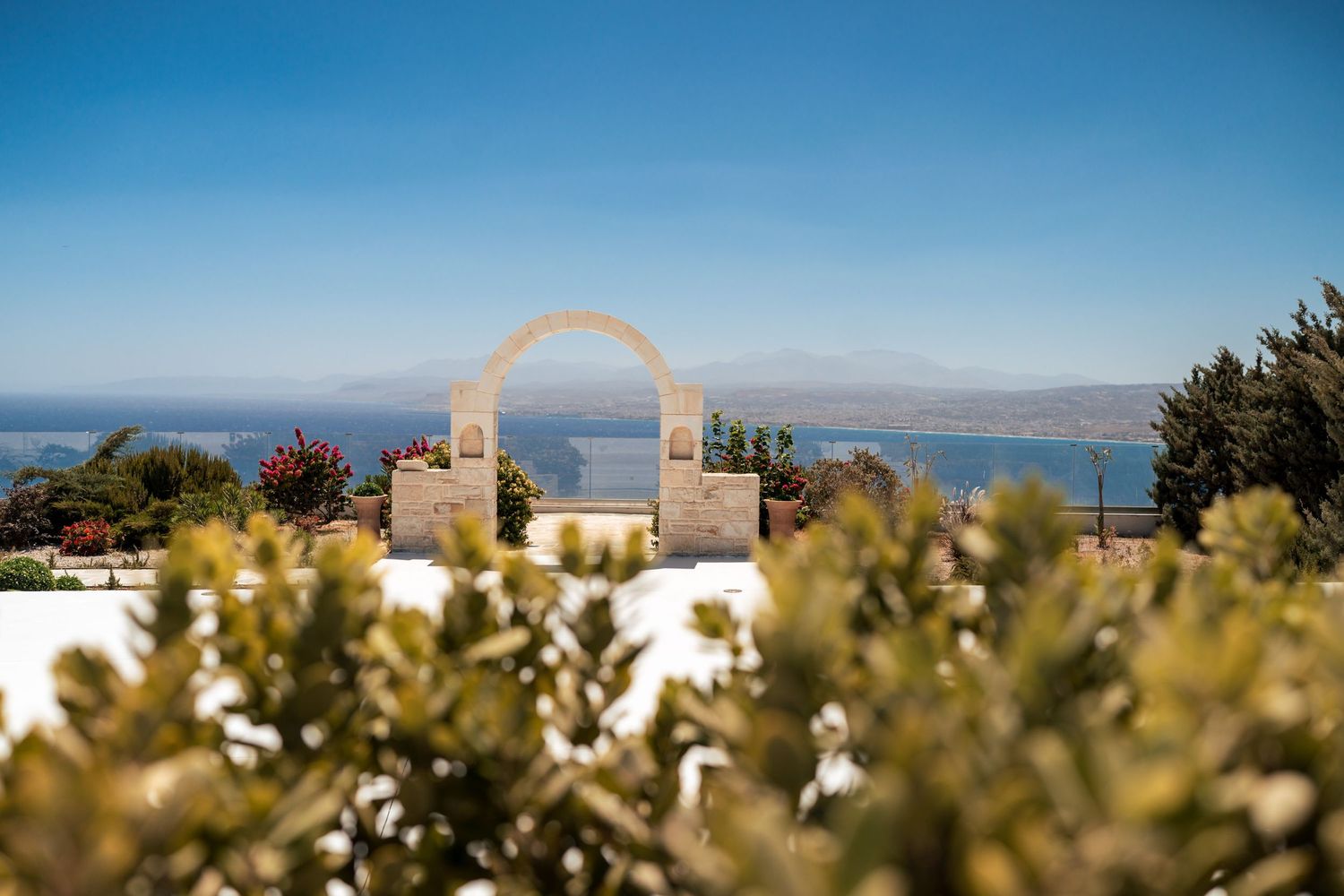 Mediterranean coastal view with white buildings and ocean vista.