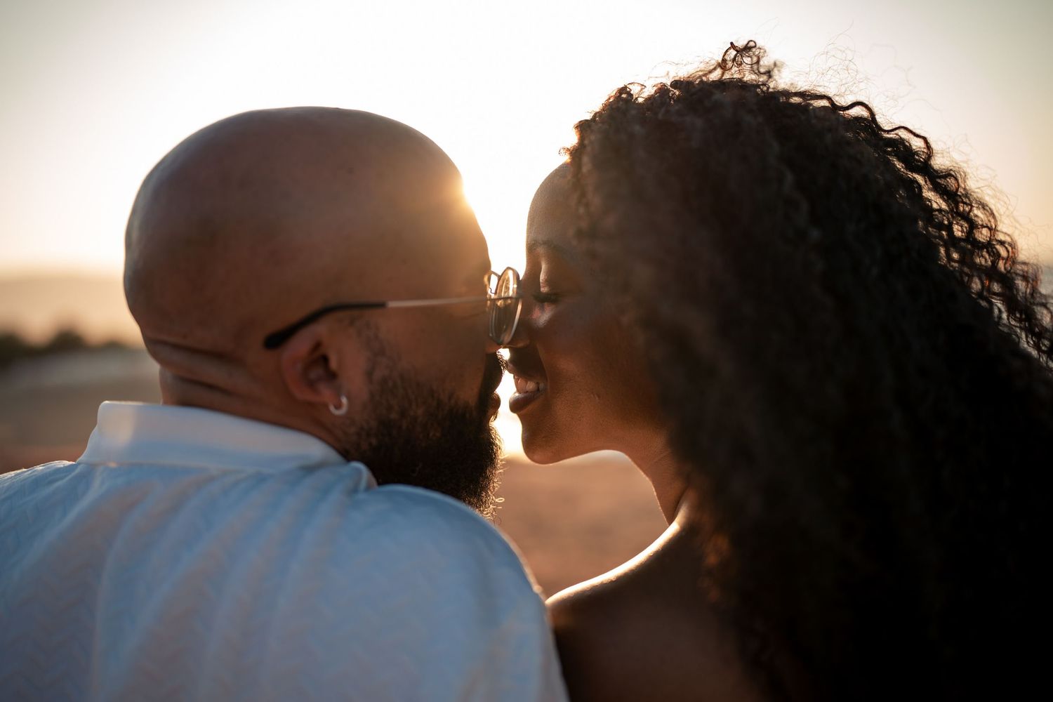 Intimate portrait session with soft backlight creating silhouette effect.