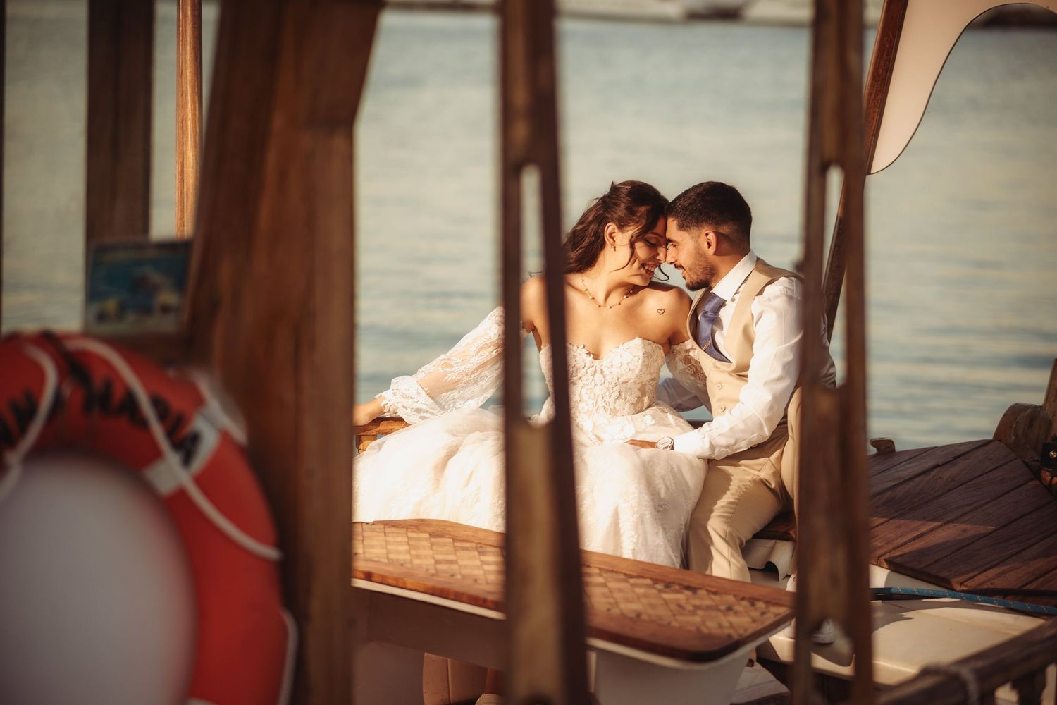 Intimate wedding moment captured through wooden cabin windows.